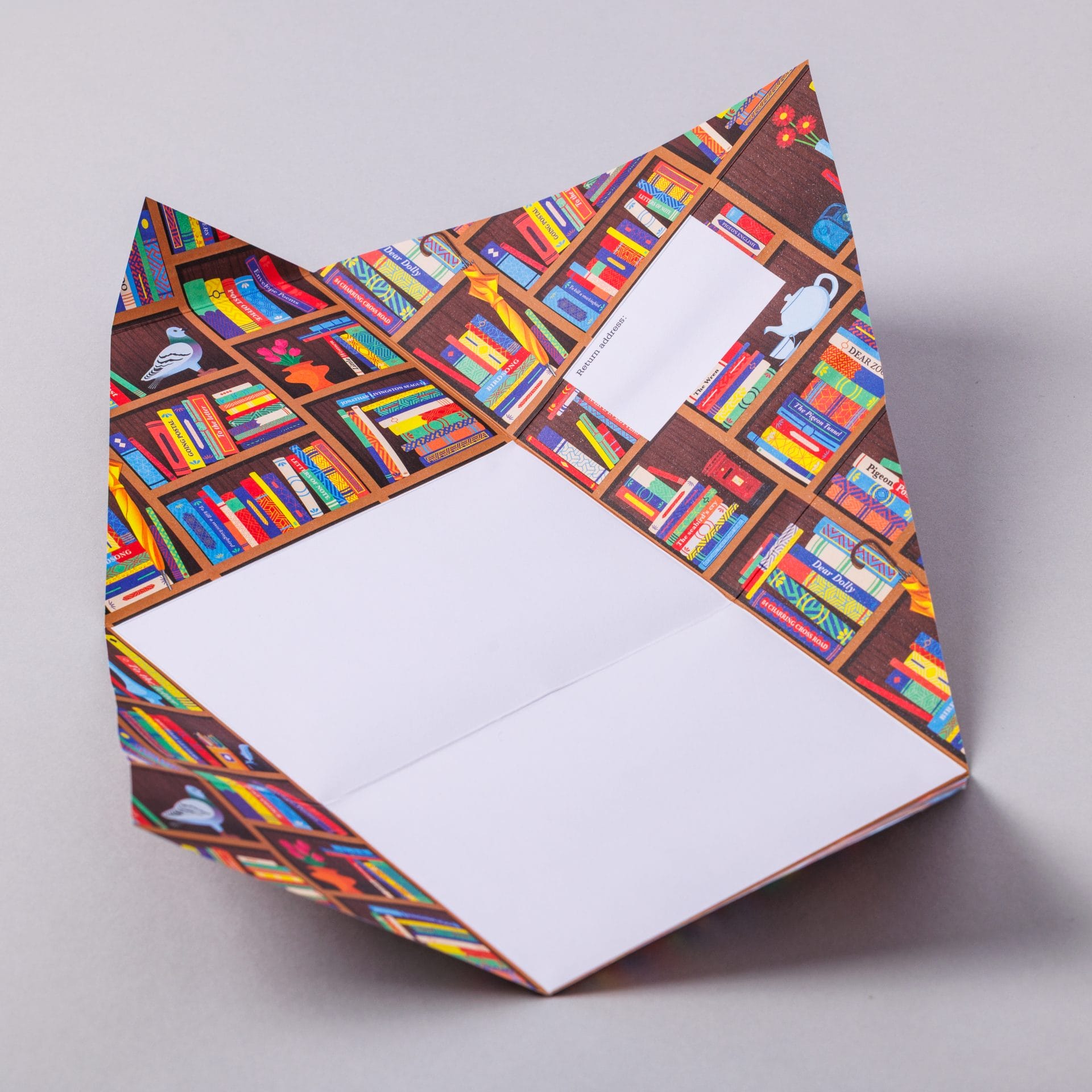 Unfolded Bookstore Pigeon showing bookshelf design interior on grey background