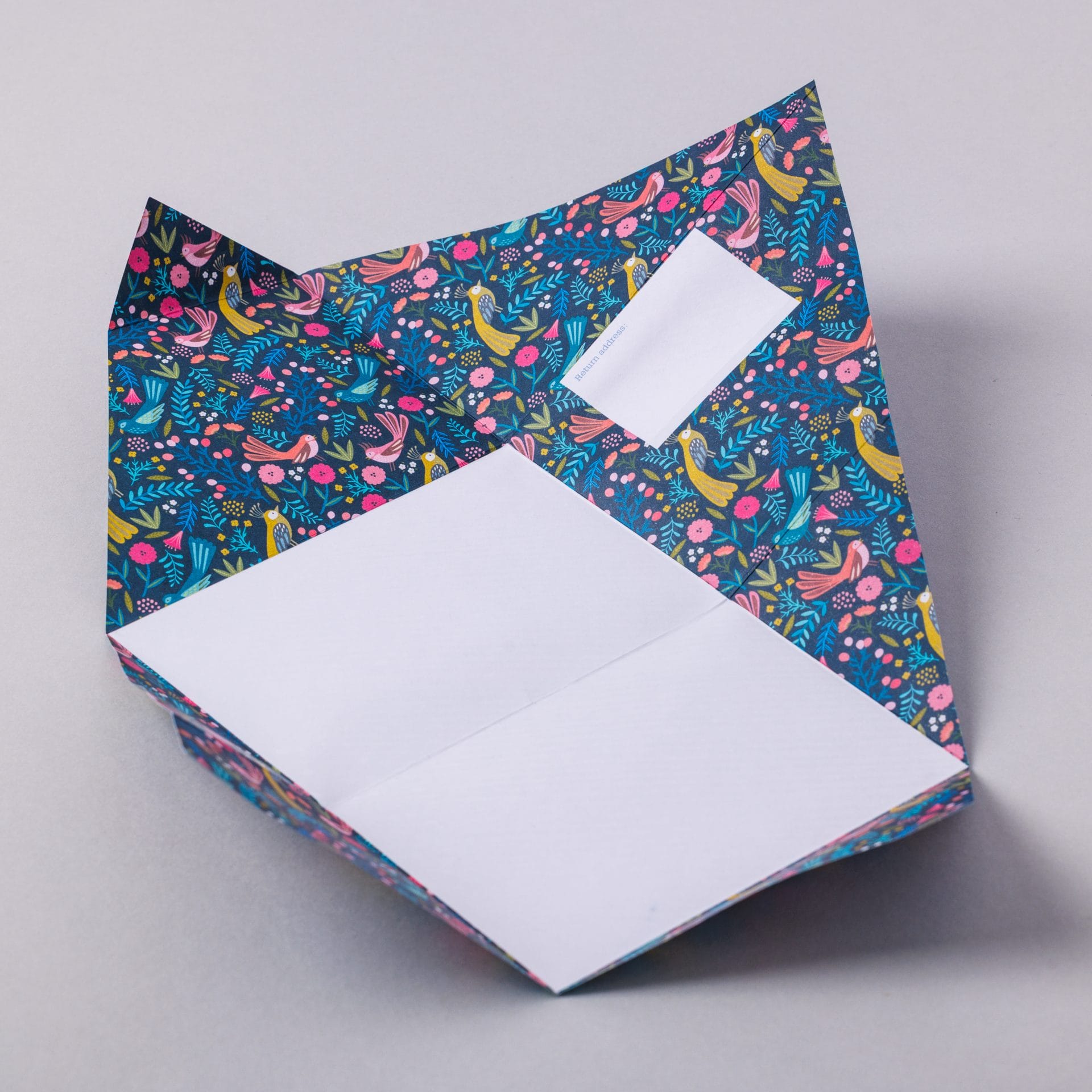 Unfolded Magical Menagerie Pigeon showing tropical animal interior on grey background