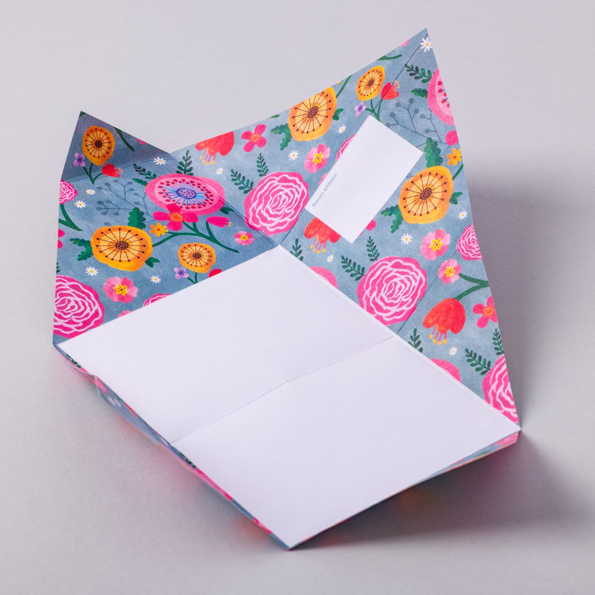 Unfolded Wildflower Pigeon with colourful floral interior on grey background