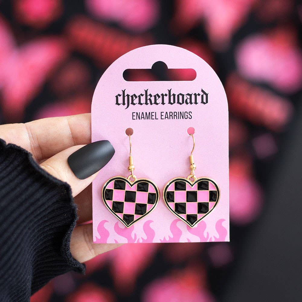 Pink and black checkerboard heart enamel earrings on pink backing card