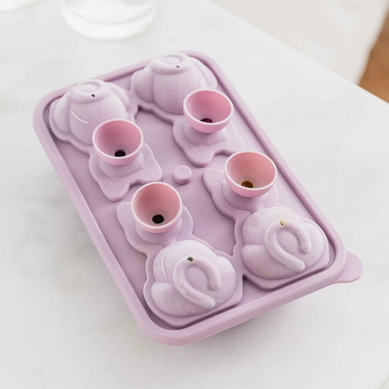 Pink cat ice cube tray with built-in funnels for filling