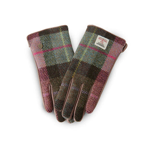 Pink and green tartan Harris Tweed ladies gloves with leather trim on white background.