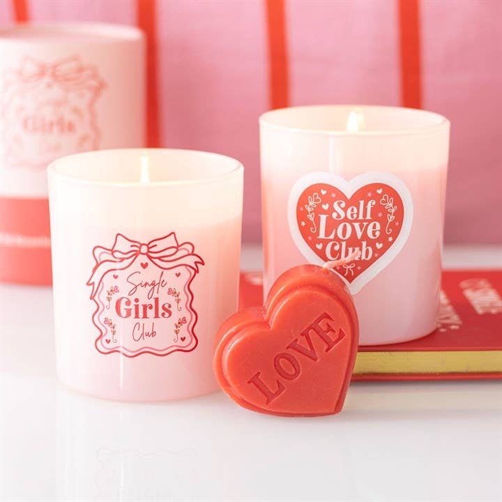 Red heart candle burning showing warm glow