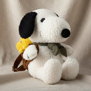 Snoopy with Woodstock in backpack soft toy on linen background