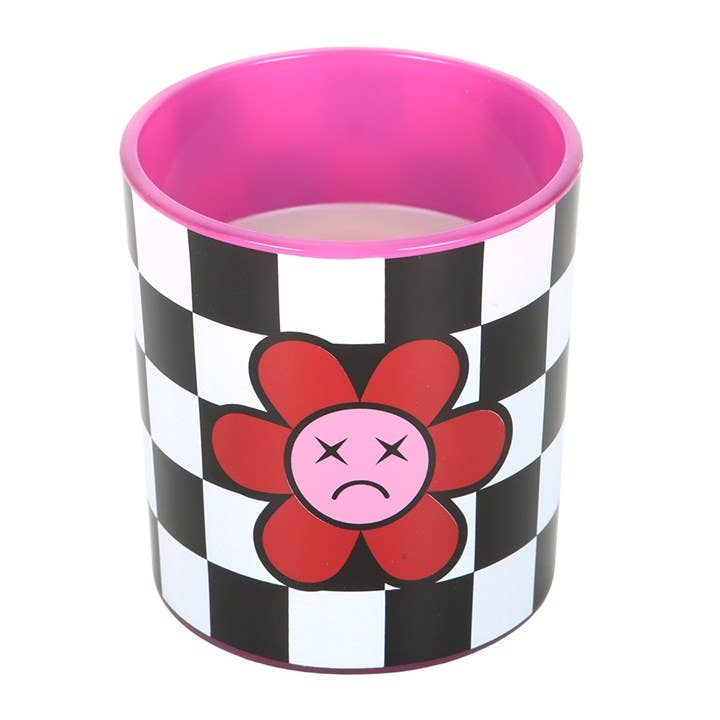 Close-up of Sad Flower Candle showing black and white checkerboard pattern and pink interior glass with sad flower motif.