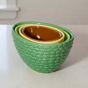 Avocado measuring cups stacked together on kitchen countertop showing nesting design
