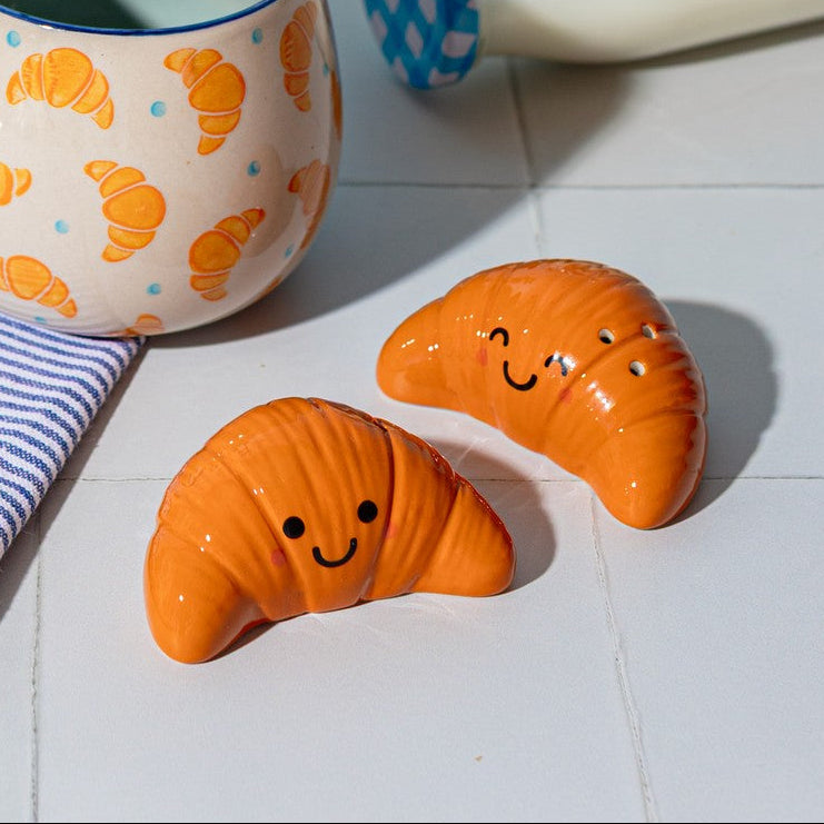 Croissant salt and pepper shakers with smiley faces on white tiles lifestyle