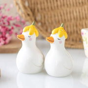 Daisy duck salt and pepper shakers styled with pink flowers and wicker basket