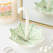 Umbrella trinket dish displayed with flowers and jewellery items