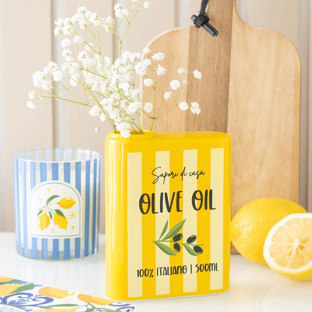 Yellow/white striped vase with olive oil label and flowers
