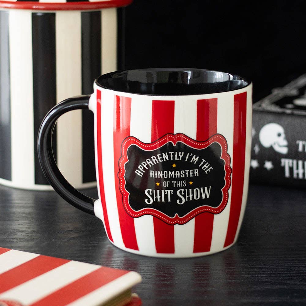 Red and white striped mug with ringmaster text on dark moody background