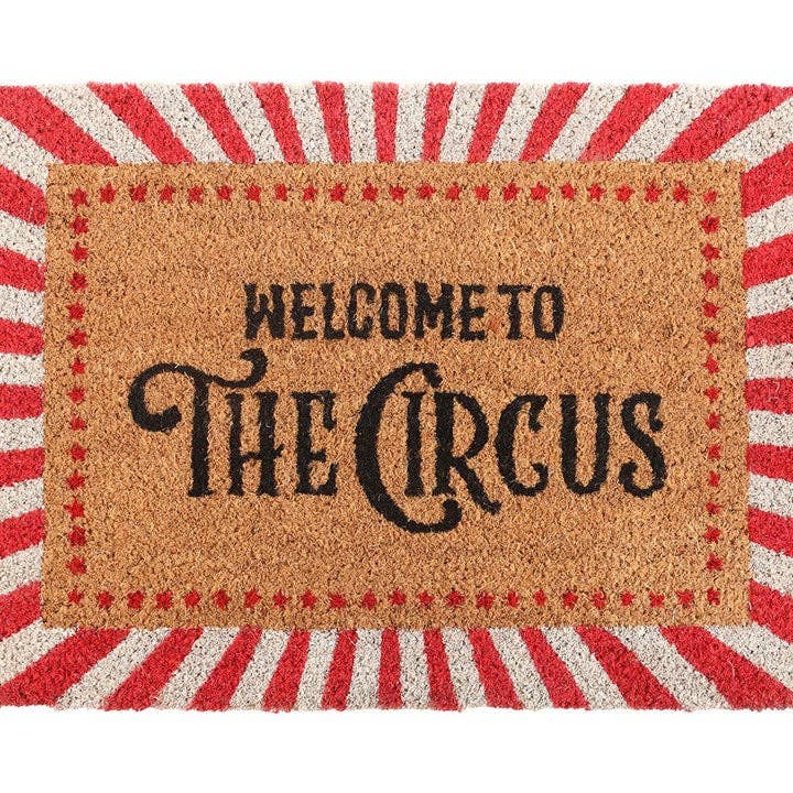 Close-up of doormat text and striped border detail