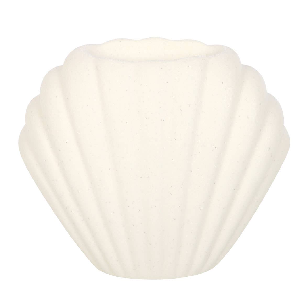 Seashell oil burner in home setting with soft lighting