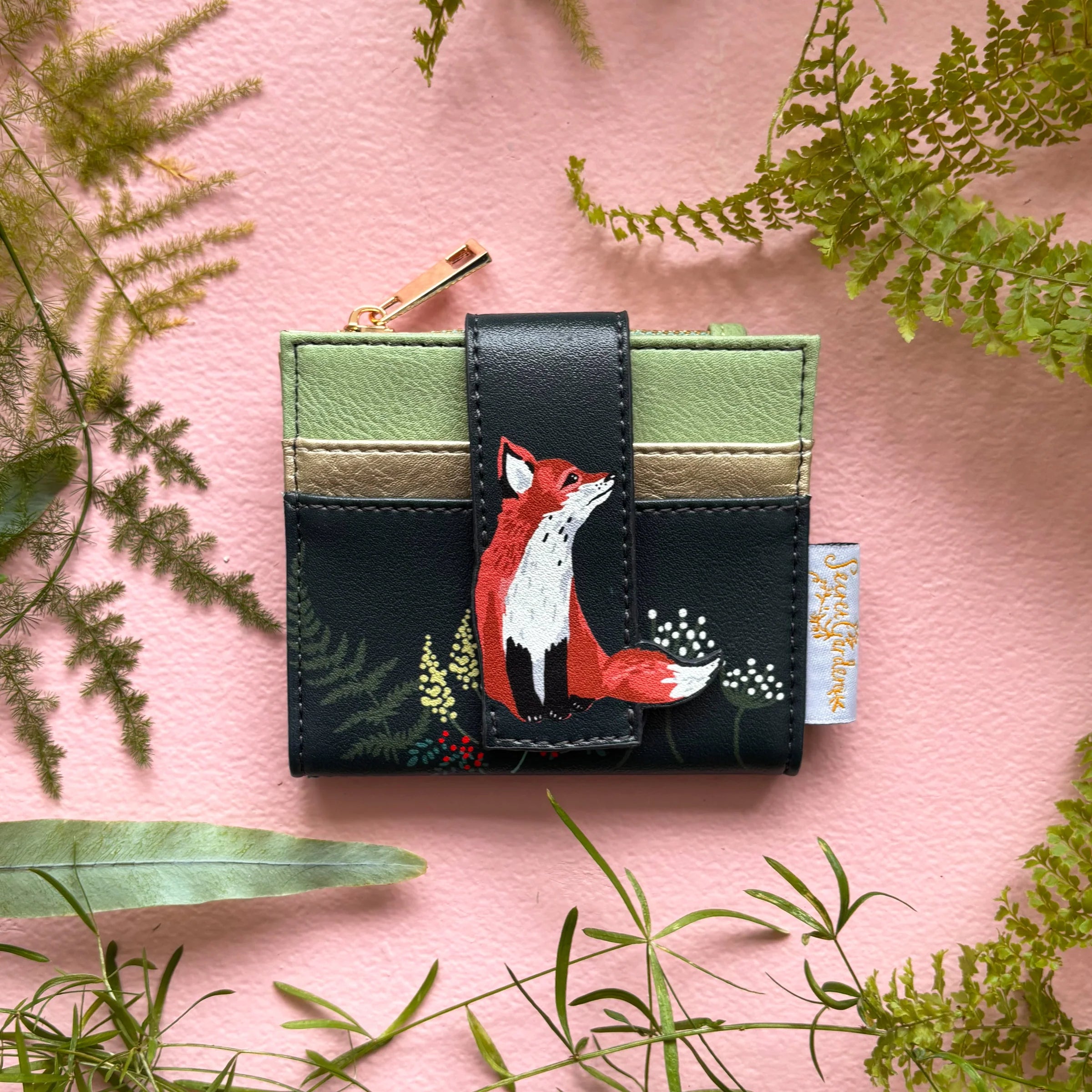 Secret Garden fox foldover cardholder in green faux leather on pink background