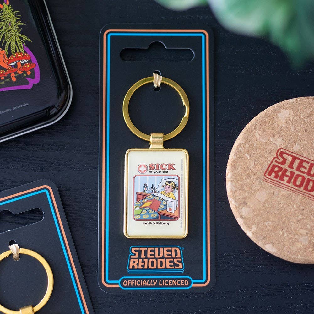 Sick of Your Shit enamel keyring by Steven Rhodes on branded packaging