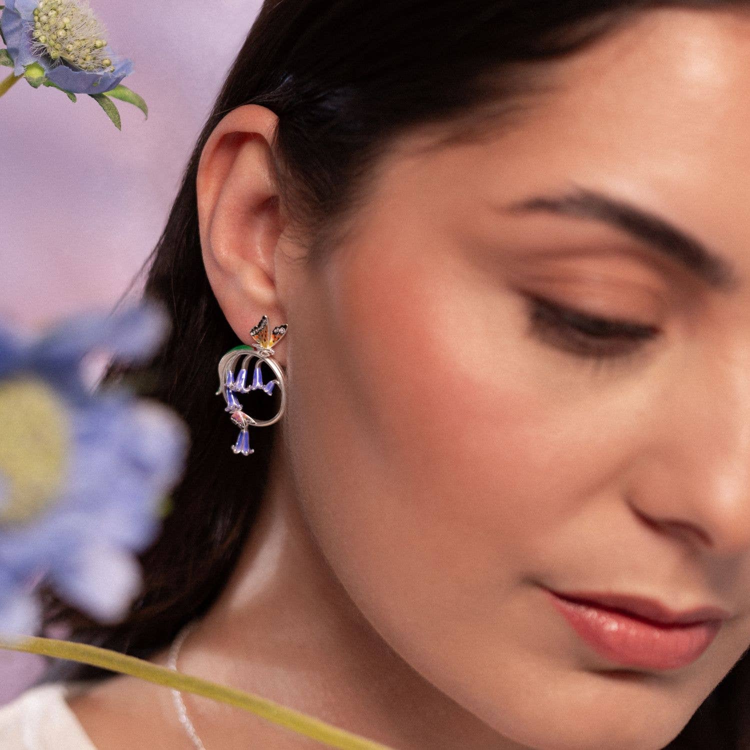 Side profile of model wearing Bluebell & Butterfly Hoop Earrings showing butterfly and bluebell motif.