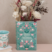 Little Women book vase holding white dried flowers