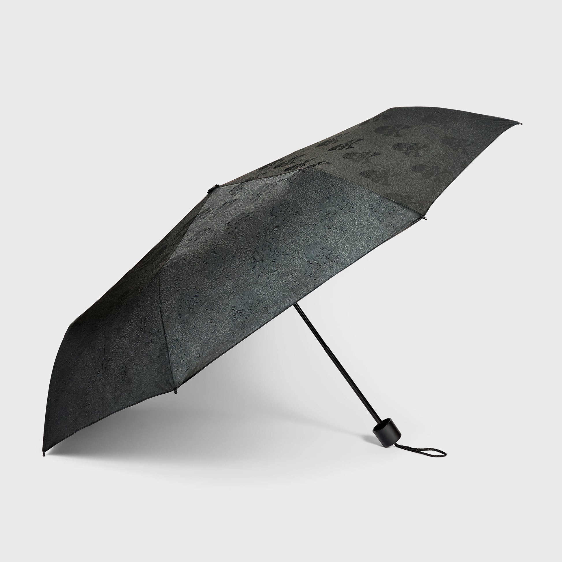 Hidden skulls umbrella open side view showing compact telescopic design