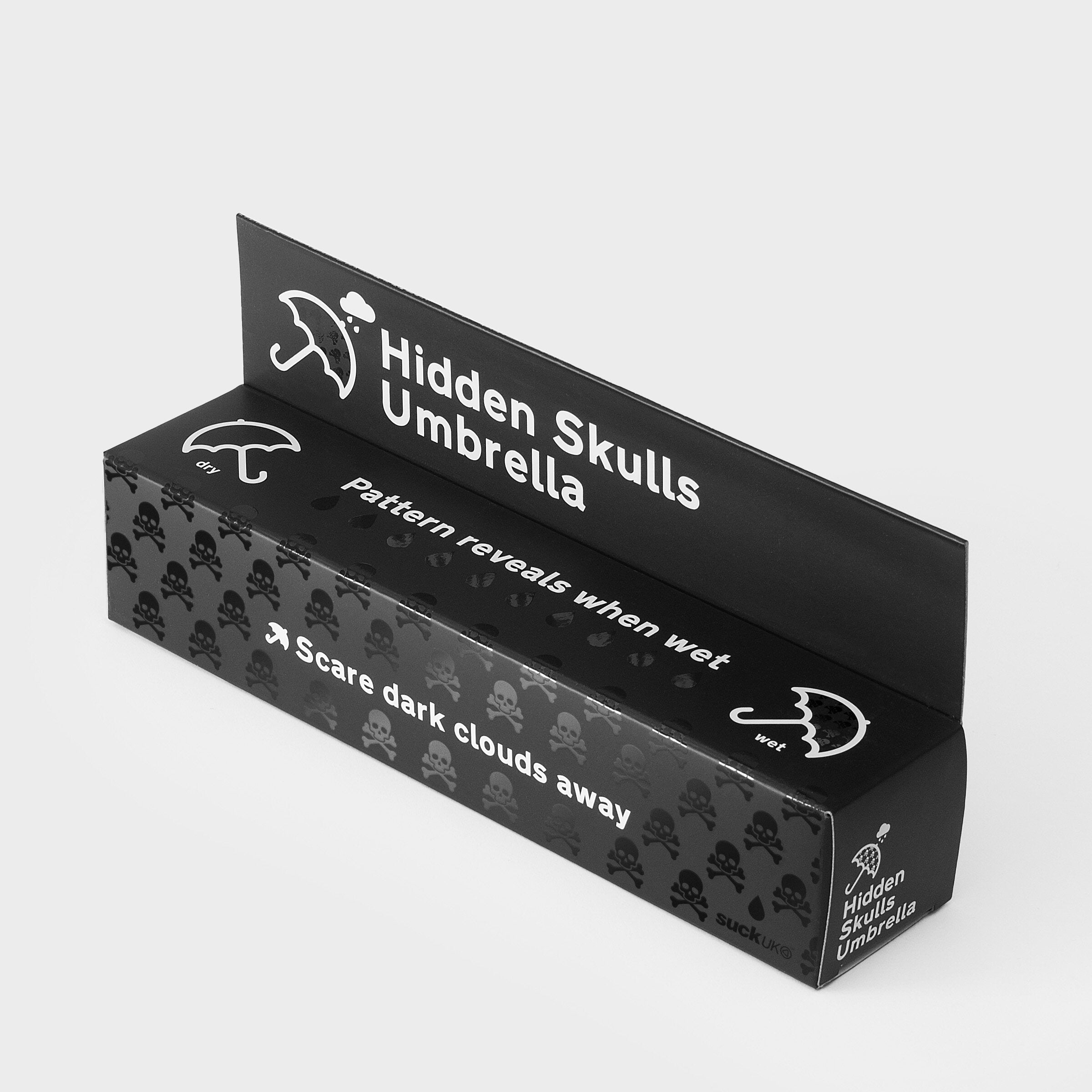 Hidden skulls umbrella in black gift packaging box on grey background