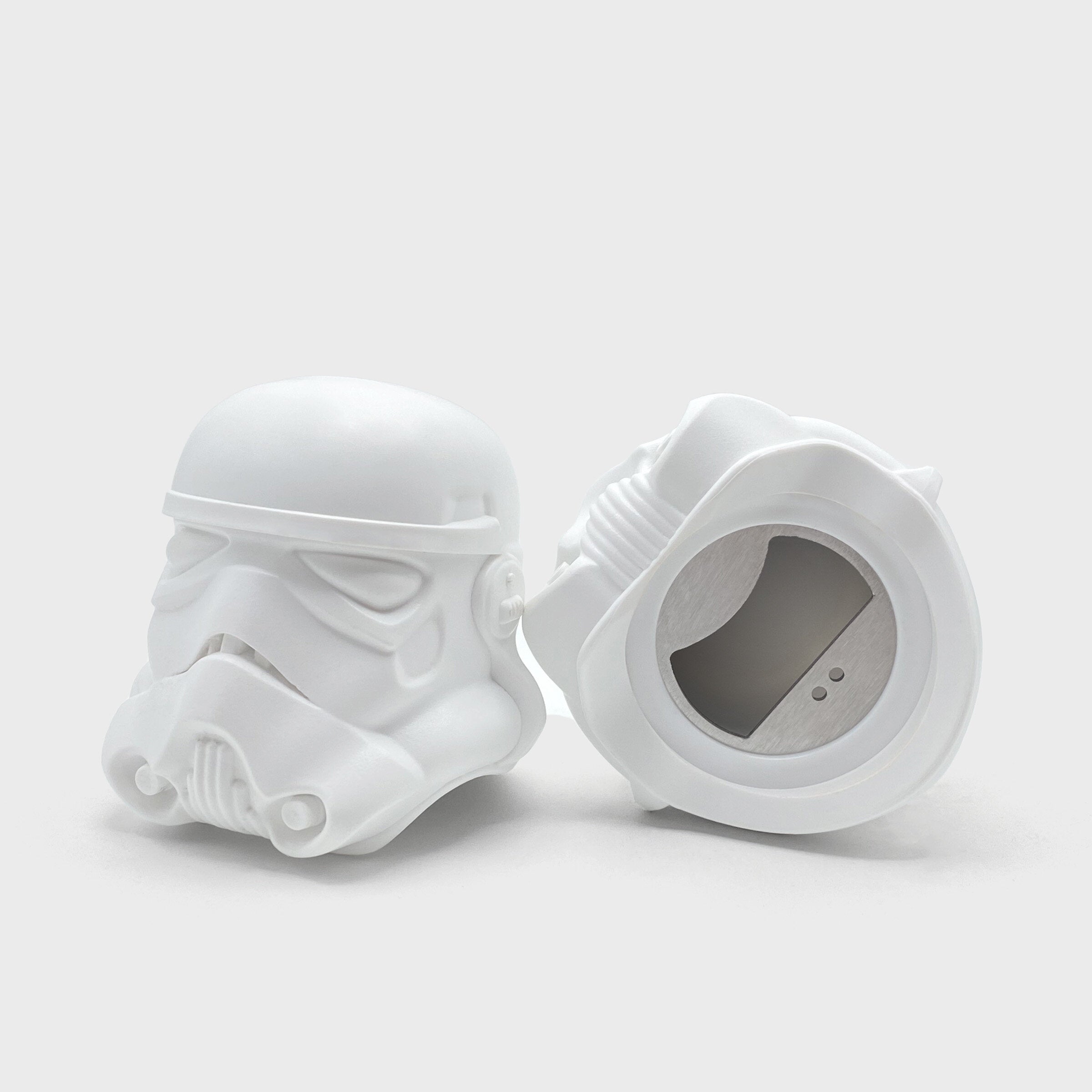 Stormtrooper bottle opener pair showing stainless steel opener underneath, light grey background