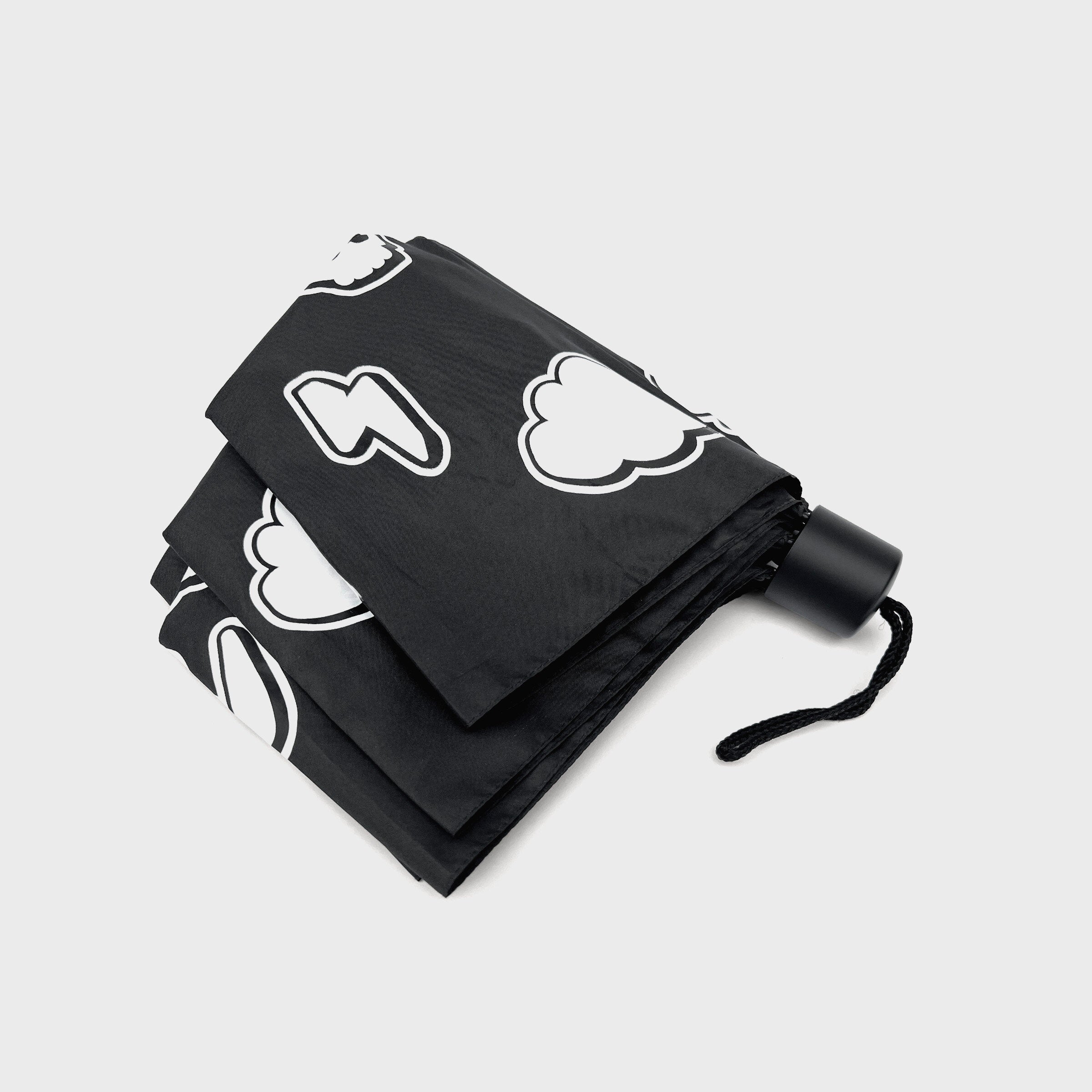 Weather pattern umbrella folded showing white icons on black fabric