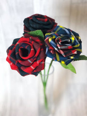 Tartan stem roses trio with green leaves in a glass vase