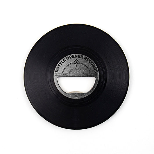 Black vinyl bottle opener shaped like a record on white background