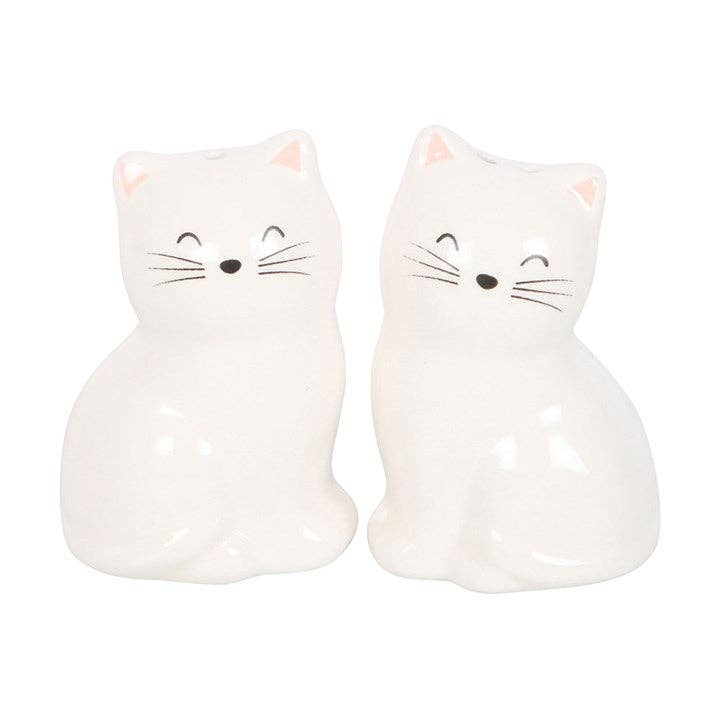 White cat shakers showing closed eyes whiskers and pink ears detail