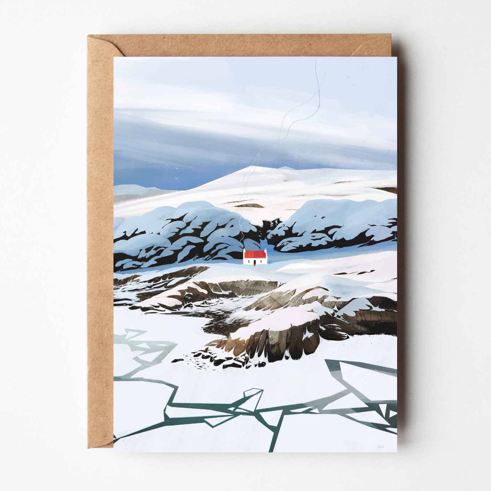 Winter at Croft Cottage greeting card showing illustrated snowy Scottish landscape with croft cottage and kraft envelope.