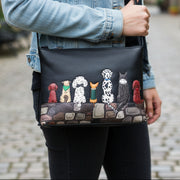 Black leather crossbody bag with puppy dog applique front view