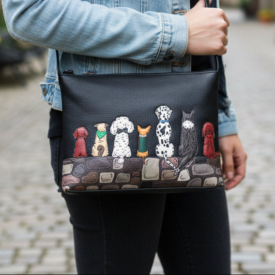 Black leather crossbody bag with puppy dog applique front view