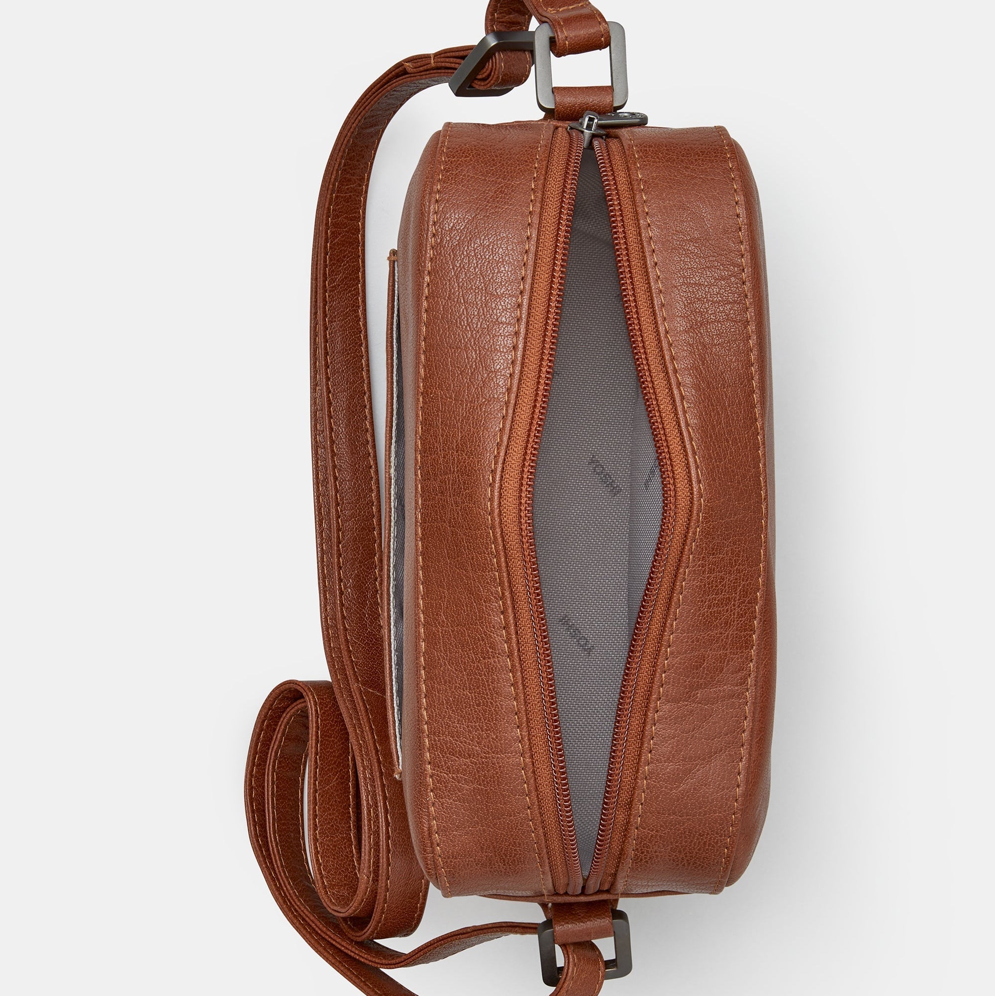 Brown leather camera bag overhead flat lay view