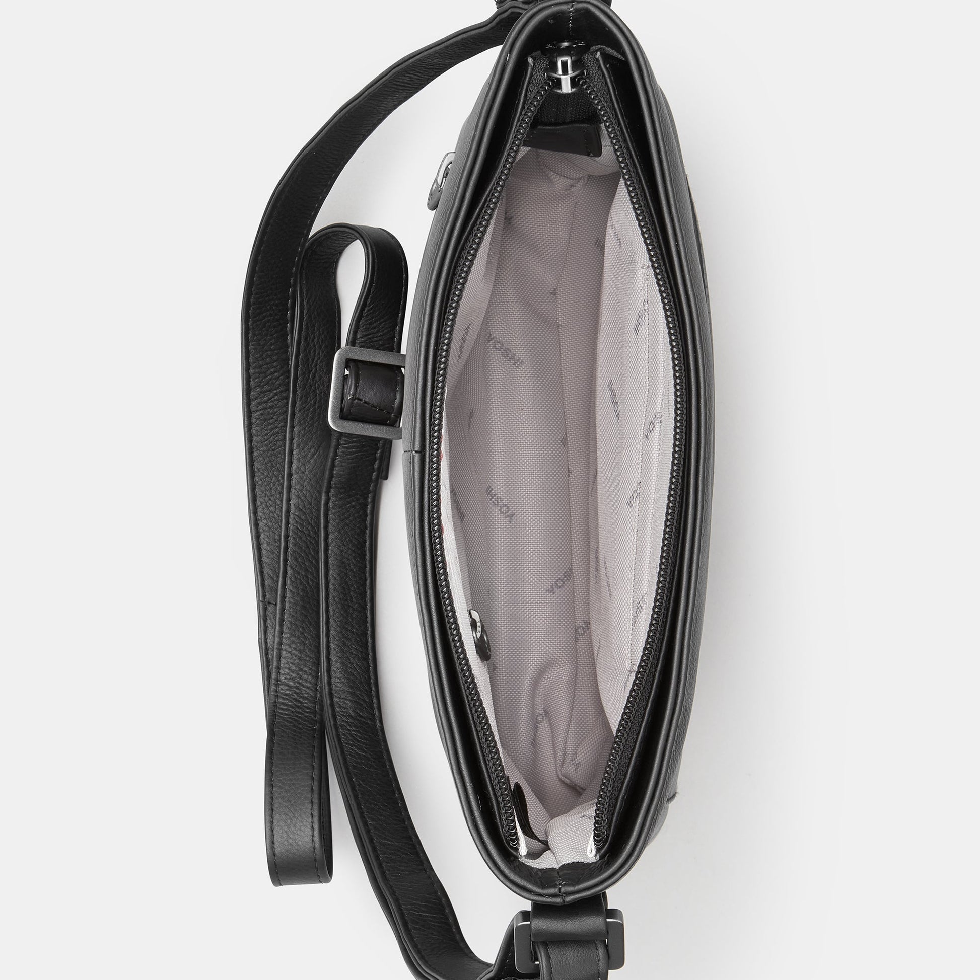 Black leather crossbody bag overhead view showing grey patterned lining interior