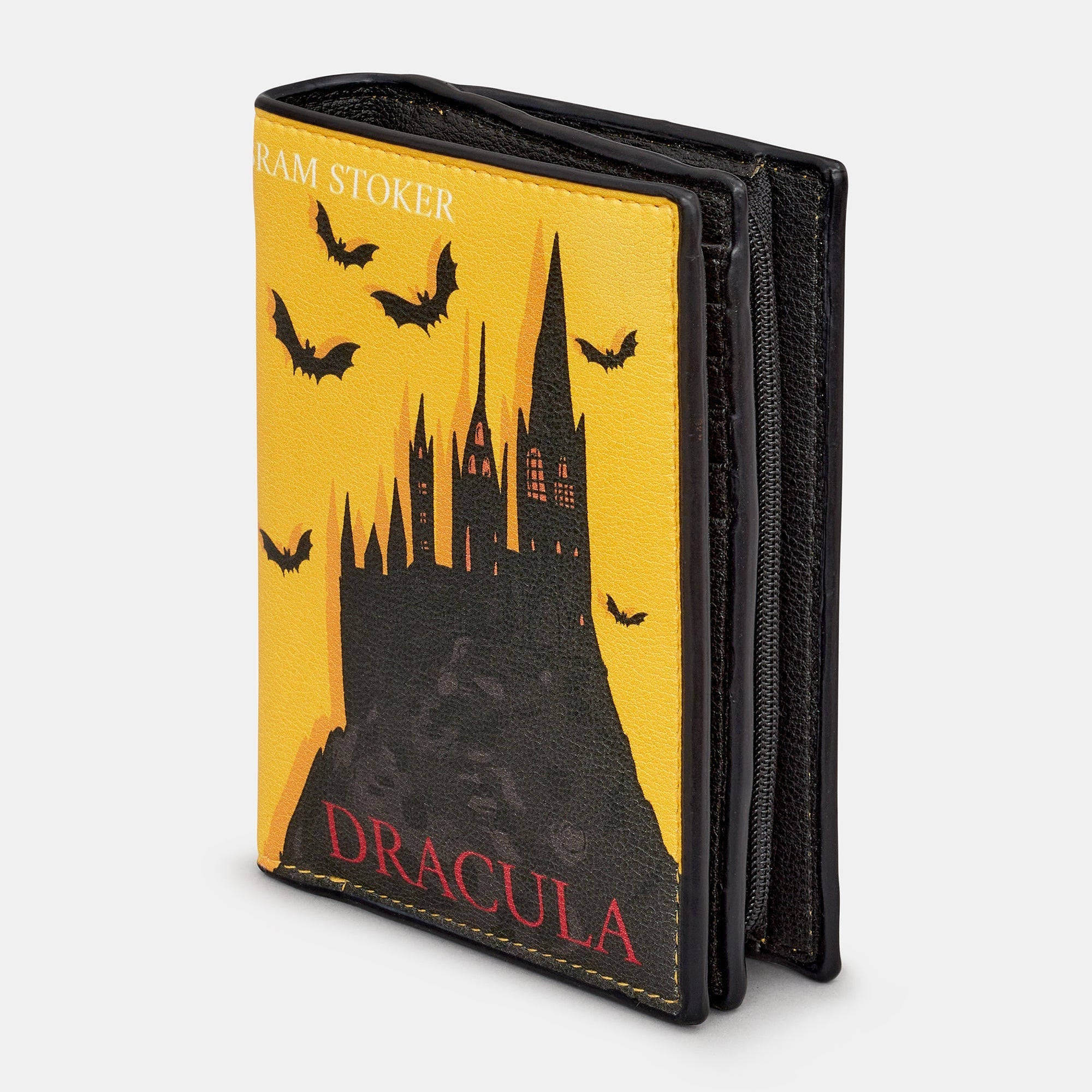 Dracula book purse slightly open showing zip coin section on white background
