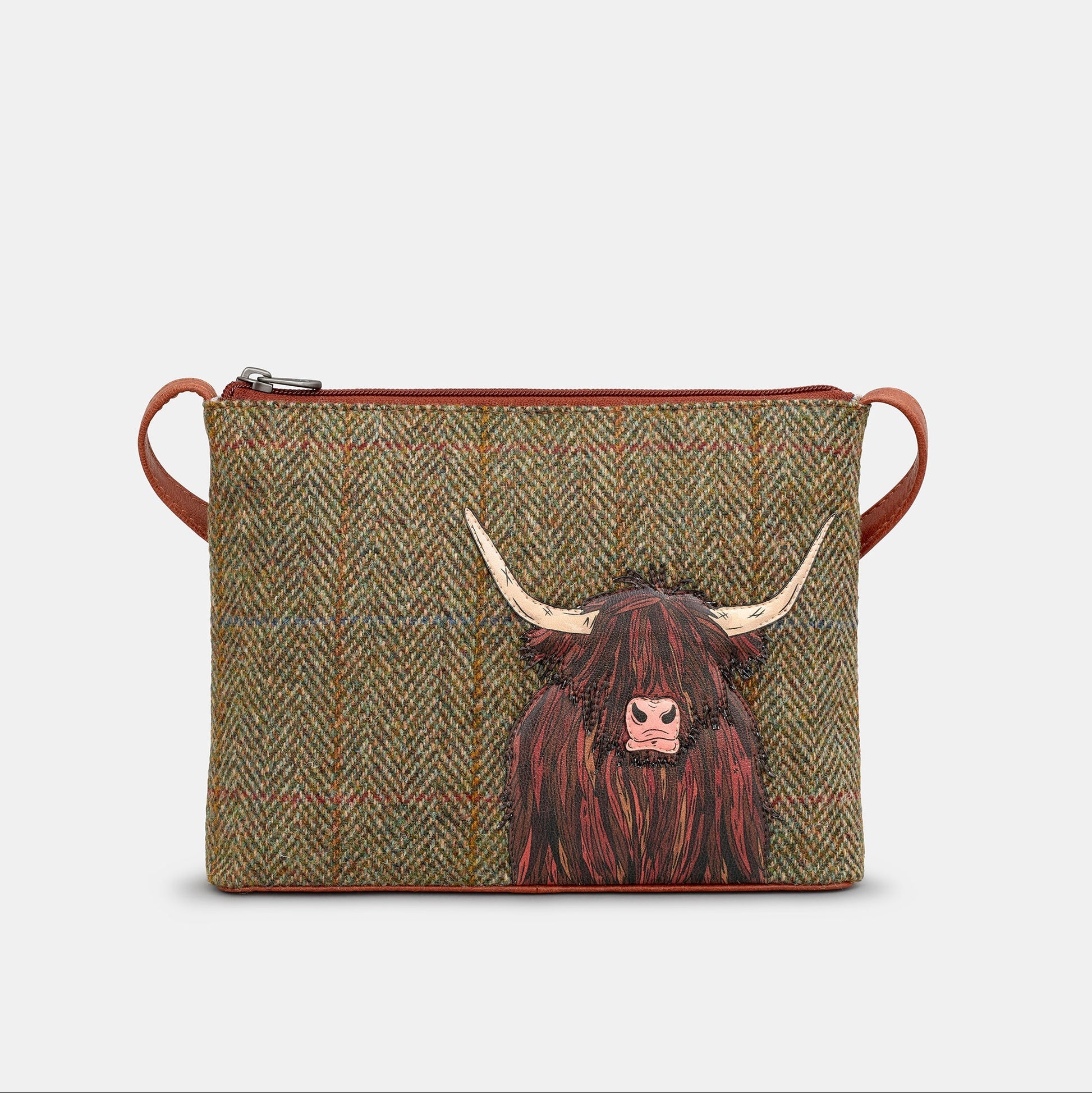 Highland cow crossbody bag front detail showing tweed and leather applique on white background