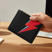 Lightning bolt black leather wallet held in hand over desk showing red bolt design