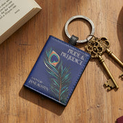 Pride and Prejudice keyring on wooden surface with antique keys and open book