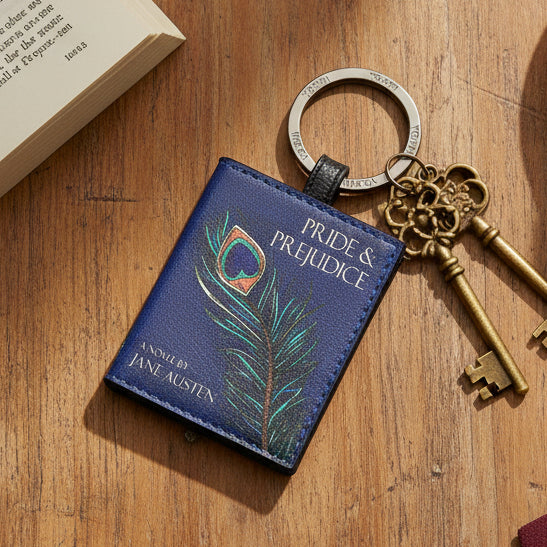 Pride and Prejudice keyring on wooden surface with antique keys and open book