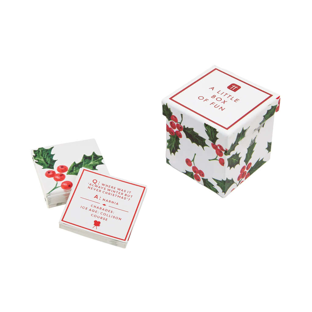 A box of family friendly trivia questions and charades to play around the diner table. The box is open with a couple of cards as an example. 