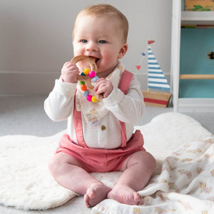 Baby using one of the Hairy Coo wooden highland cow teething rings. 