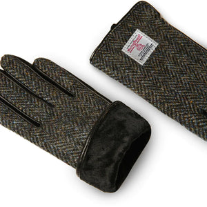 Pair of mens Harris Tweed Black and Grey Herringbone Gloves with one of the gloves turned inside out to show the lining. 
