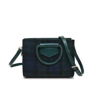 An elegant Black Watch Tartan Harris Tweed Arran Tote Bag made with genuine Harris Tweed fabric featuring a braided handle and optional adjustable shoulder strap. The bag is compact yet spacious, with a zip fastening and a luxurious PU leather outer.