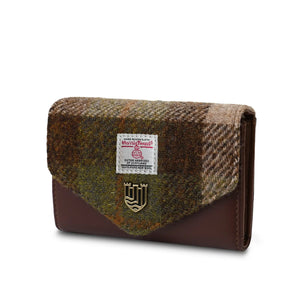 A side view of a brown chestnut tartan Harris Tweed purse with matching PU leather accents. The purse has a compact design with a zippered main compartment and additional pockets and card slots for organisation. 