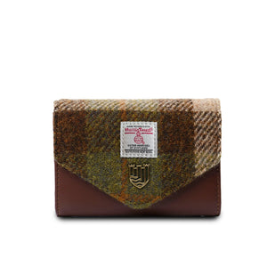 A brown chestnut tartan Harris Tweed purse with matching PU leather accents. The purse has a compact design with a zippered main compartment and additional pockets and card slots for organisation.