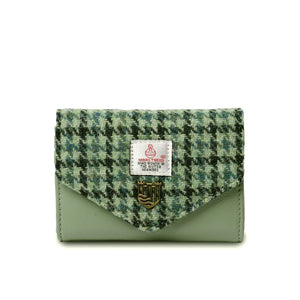 Green dogtooth Harris tweed purse with a zippered main compartment and interior pocket. The exterior has a slip pocket for quick access to items.