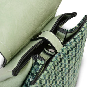 Close up of the internal stud closer on the Green Dogtooth Harris Tweed Backpack. 