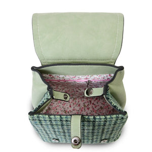 Inside the Islander Harris Tweed Green Dogtooth Backpack showing the internal lining and the secure zipped pocket. 