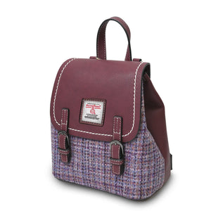 Side view of the Islander Harris Tweed Violet Mini Dogtooth Backpack showing the burgundy leather and purple fabric design.