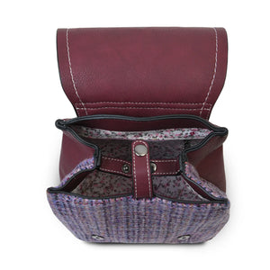 Inside the Islander Harris Tweed Violet Dogtooth Backpack showing the button closers, interal lining and zipped pocket.