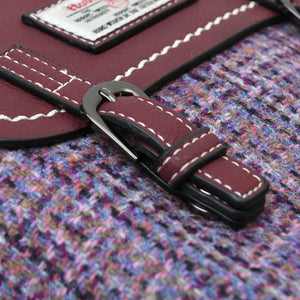 Close up view of the Violet Dogtooth Harris Tweed fabric that makes up the Jura Backpack.